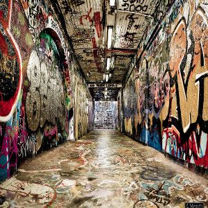 Image of a graffiti filled tunnel with stairs at the end in the distance for a hip hop rap beat titled Hit 'em.