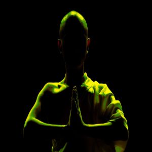 Image of the upper body of a Shaolin monk silhouette with hands together as if praying for a hip hop rap beat titled the grail